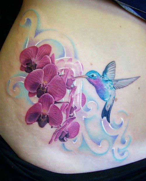 A blue shade humming bird with three flowers