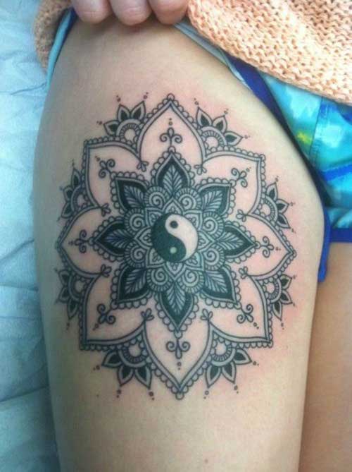 Big black color creative mandala on the front portion of the thigh