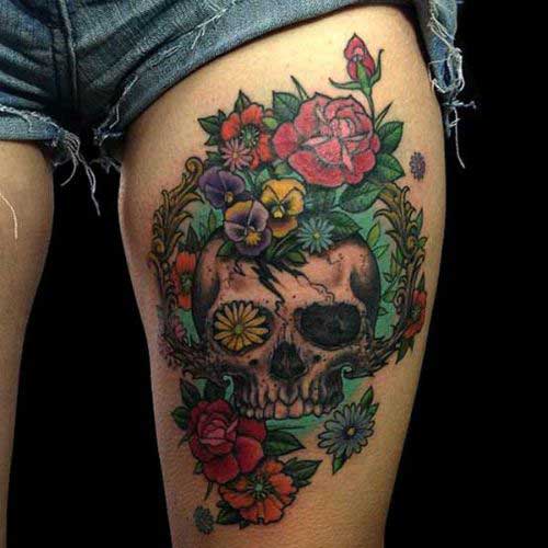 Colourful human skull with multiple flowers On Thigh