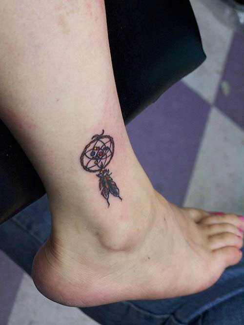 Dream catcher with multicoloured feather on leg
