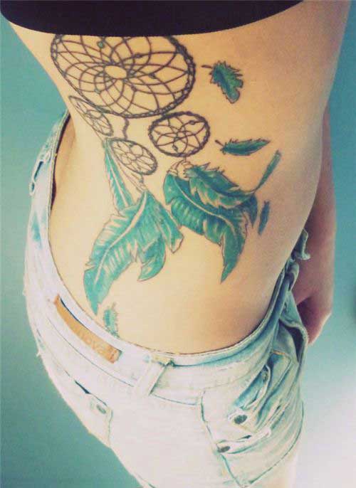 Dream catcher with three hoops and blue feather on the ribs
