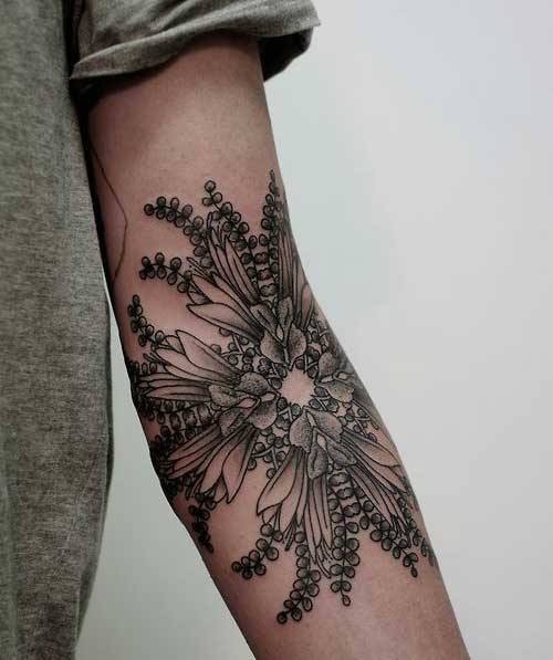 Elaborate flowery mandala with leaves on the arm amd forarm