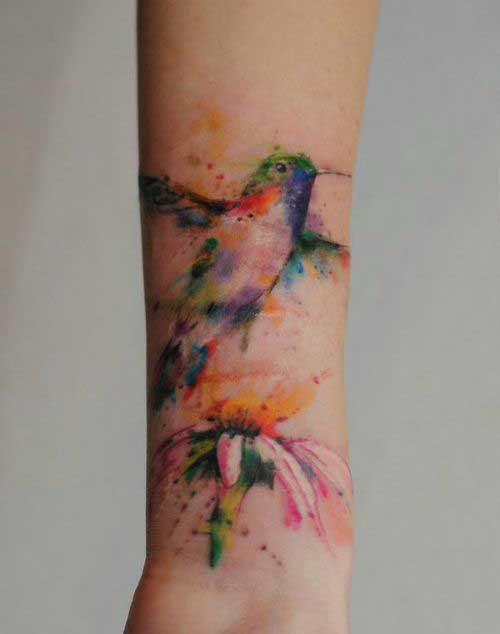 Multicoloured humming bird on hand