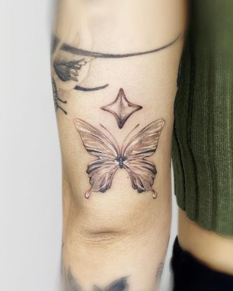 Black Butterfly And A Star Tattoo On Wrist