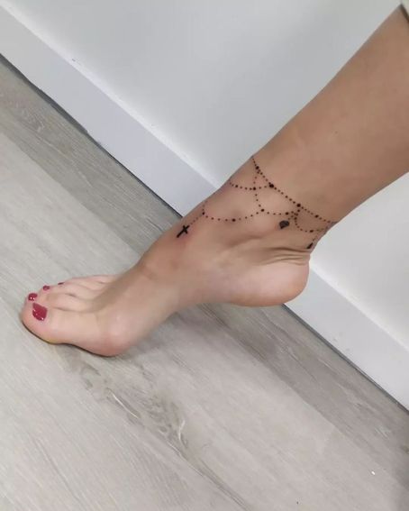 Hanging Design With Cross Tattoo On Ankle