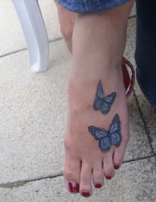 Blue butterflies foot tattoo