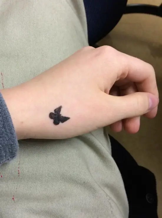 Small Black Butterfly Hand Tattoo