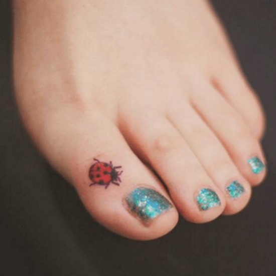 Small ladybug tattoo on toe