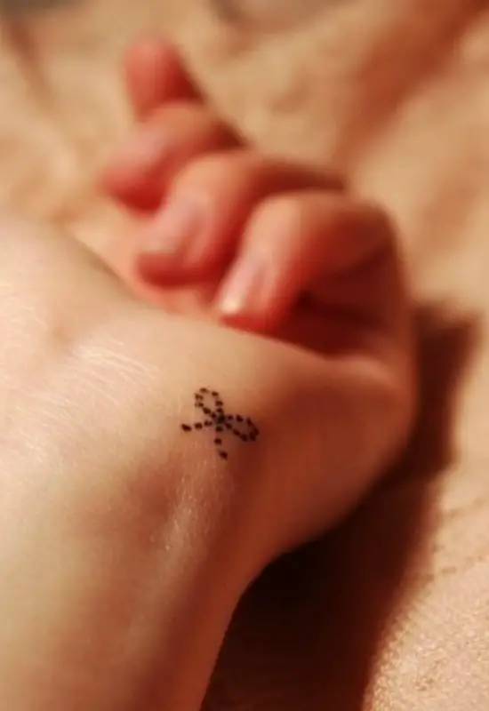 Tiny Dotted Bow Wrist Tattoo