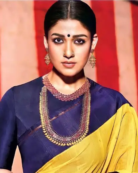 Impressive Yellow And Navy Blue Silk Saree In Nayanthara