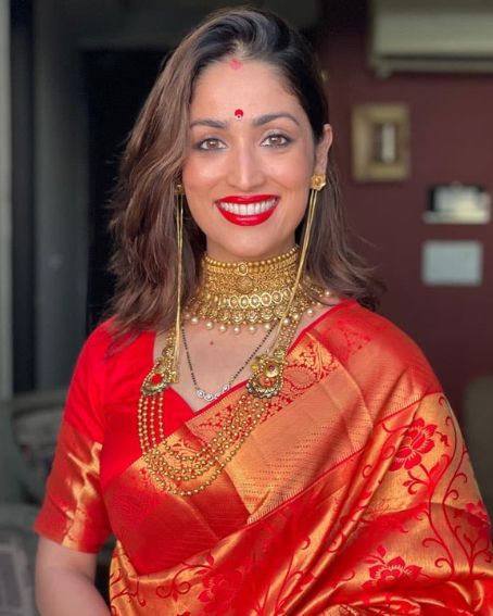 Yami Gautam In Bright Red And Gold Saree Of Zari Border