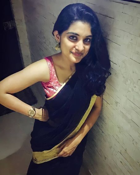 Nivetha Thomas in Black Gold Zari Border Saree with Sleeveless Pink Blouse