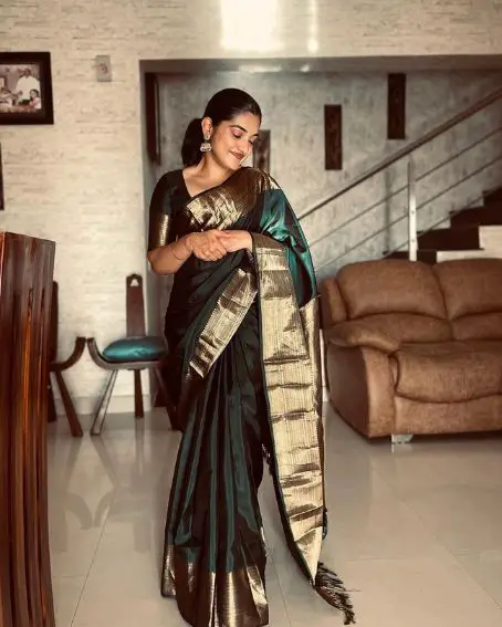 Nivetha Thomas in Bottle Green Golden Zari Border Kanjeevaram Silk Saree