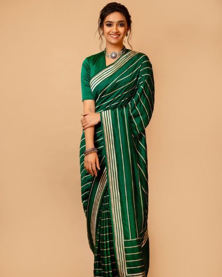 Keerthi Stand Statue In Emerald Green Silky Saree