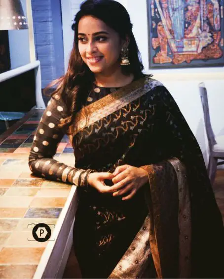 Sri Divya In Black Saree With White And Gold Border