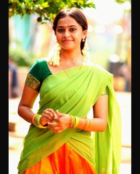 Sri Divya In Hot Green And Orange Half Saree