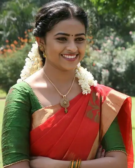 Sri Divya In Red Saree With Copper Color Border