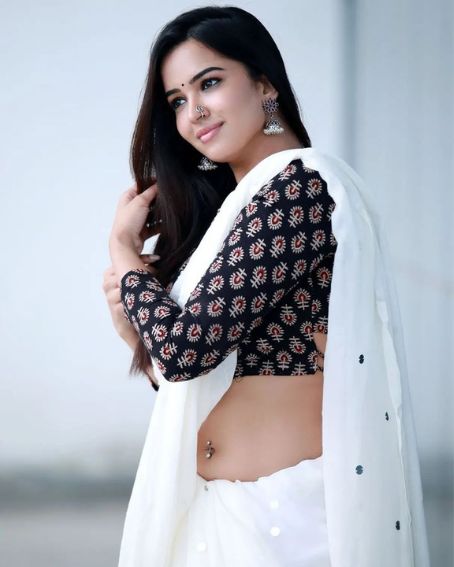 White Saree With A Black Blouse