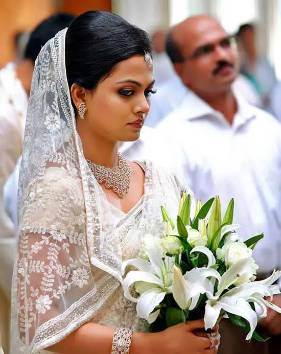 christian bride in jewellery with white saree