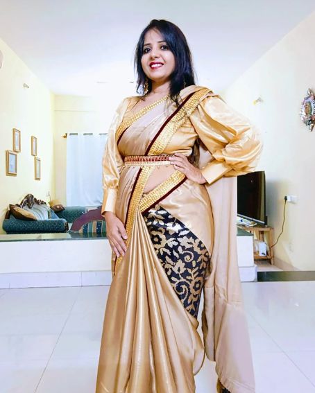 Black And Gold Saree With Red Lace Border And Gold Puff Full Sleeve Blouse
