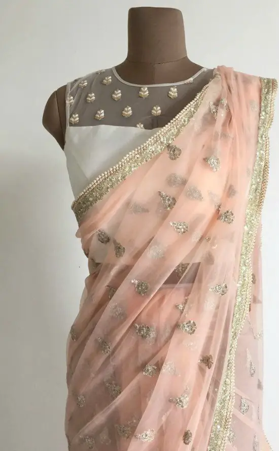 A Delicate Net Sari With Zari And Sequin Motifs All Over Complete With Pearls