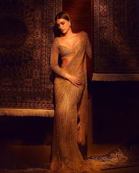 Glittering Golden Saree With Feathery Bottom And Deep Princess Cut Full Sleeve Designer Golden Blouse