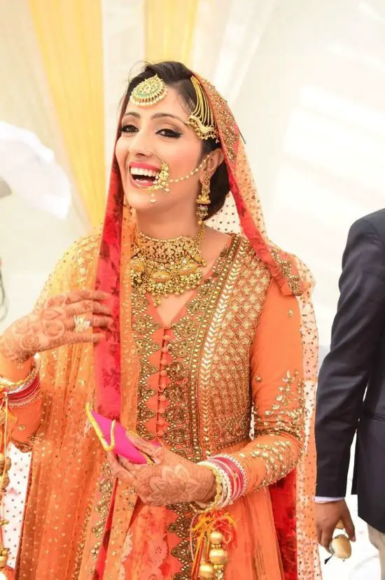 Sikh Bride Wearing Heavy Worked Orange Lenhenga