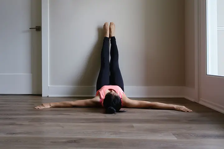 legs up the wall pose bloating