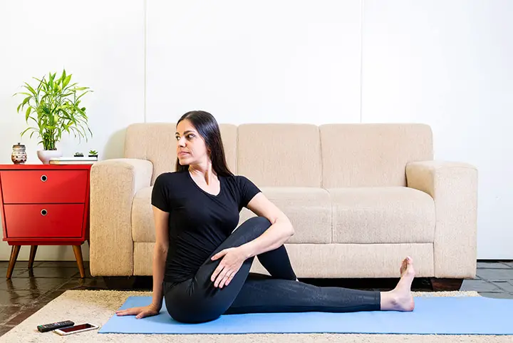 supine spinal twist pose for bloating