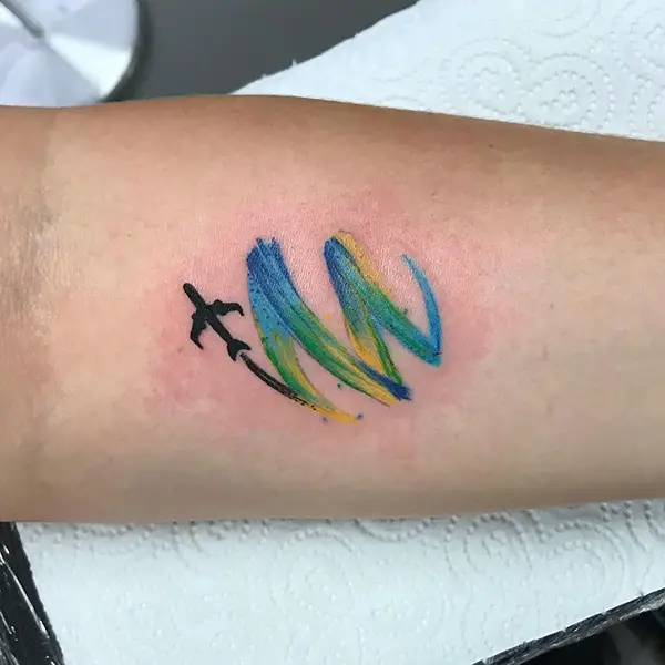 Airplane Tattoo Leaving a Colorful Trail Behind