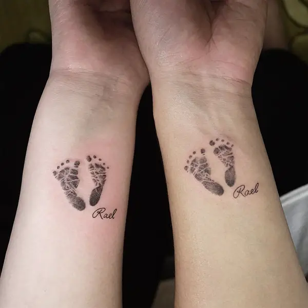 Baby Footprints on Both Parent's Arms