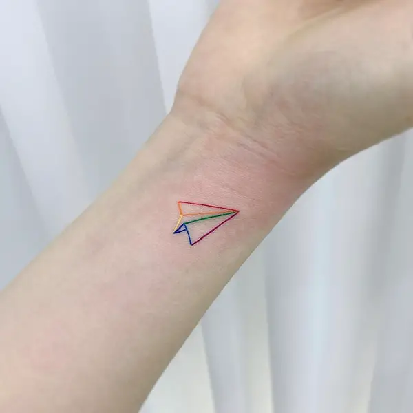 Bright-Colored Paper Plane Outline Tattoo