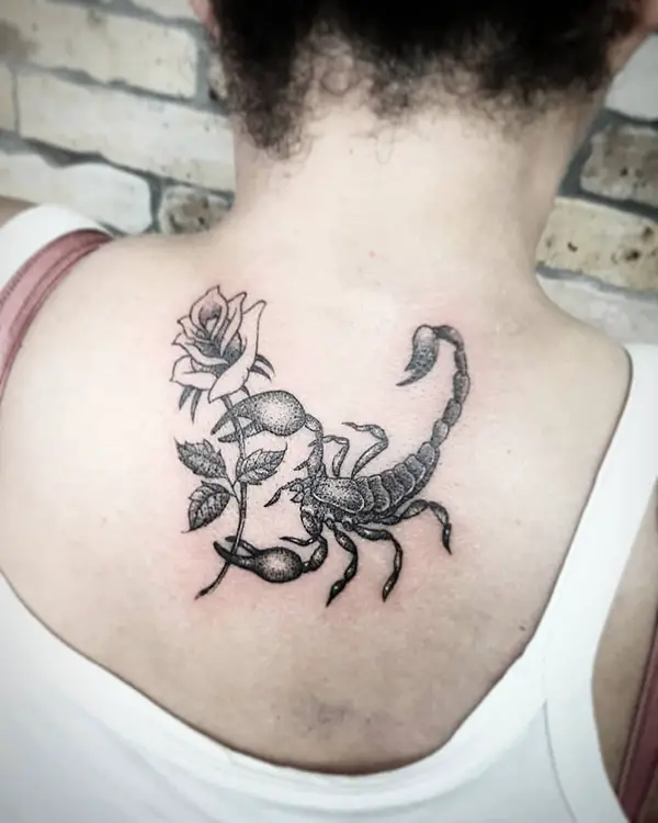 Scorpio Holding Rose Tattoo on Back
