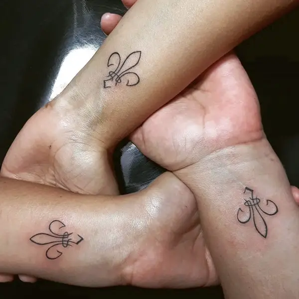 Fleur-De-Lis on Hands of 3 Persons Denoting Unity