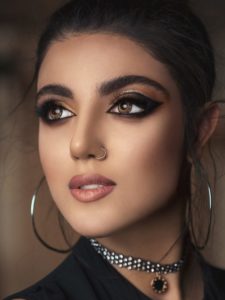 Model with smokey eyes and golden circle earrings