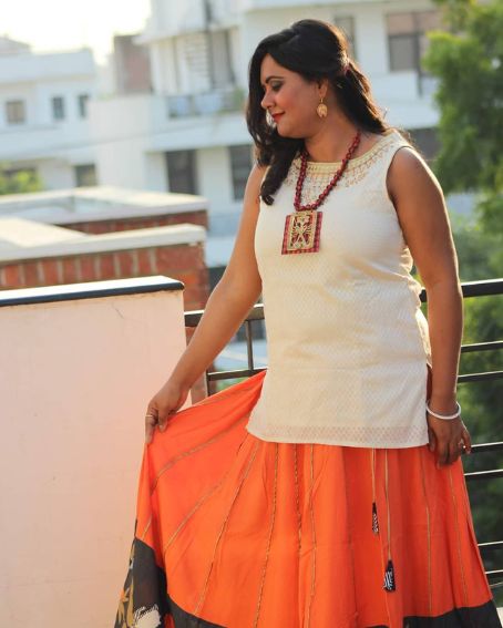 Sleeveless White Kurti with Orange Skirt