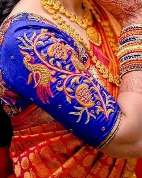 Dark blue peacock Maggam work blouse with Red silk saree