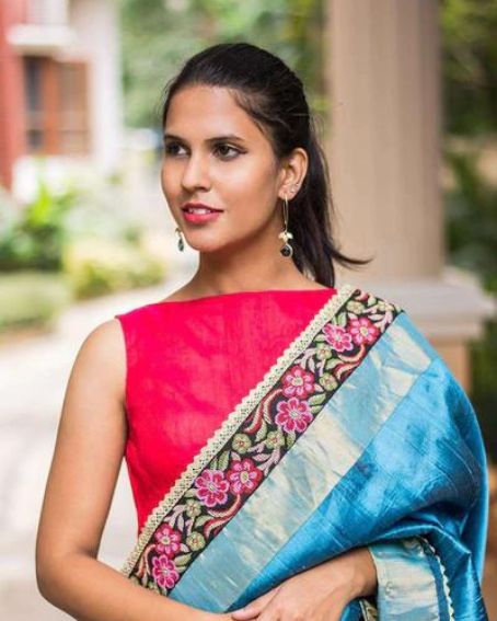 Pinkish red raw silk boatneck sleeveless blouse with skyblue saree