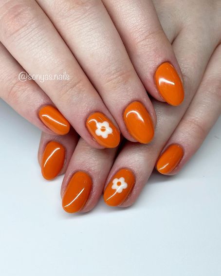 White Flowers on Orange Nails