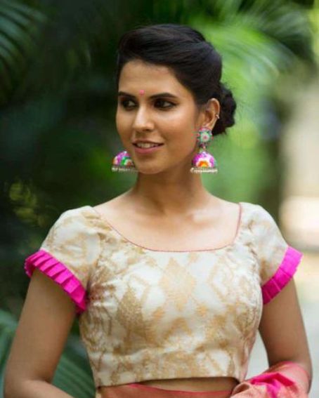White and gold brocade blouse with frills on sleeves