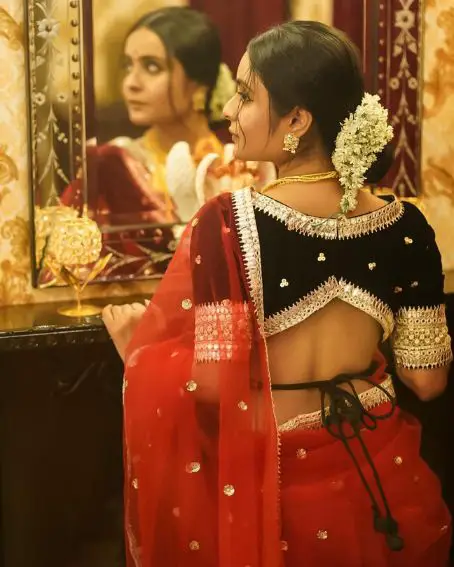 Black Velvet Blouse With A Red Saree