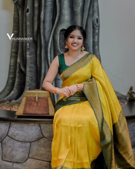 Kerala Style Yellow Saree with Green Sleeveless Blouse