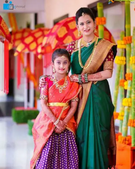 Mother In Bottle Green Saree With Her Adorable Daughter In Orange Saree