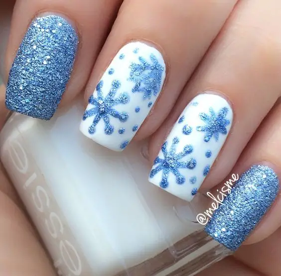 Blue and White Glittery Snowflakes Nail Art
