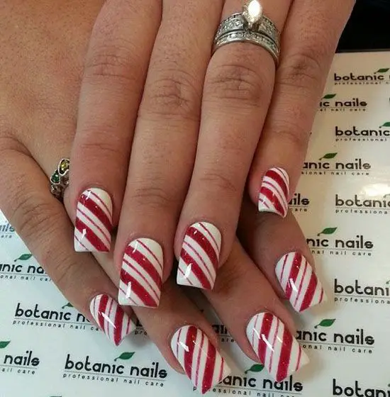 Ring in the holidays with festive nail art that's as sweet as a candy cane! Christmas is just around the corner, and what better way to celebrate than with some adorable and creative nail designs? Whether you're looking for something classic and elegant or playful and whimsical, this list of 15 candy cane nail art designs has something for everyone.From peppermint swirls and glitter accents to chic French manicures and playful Grinch-inspired designs, this list offers a variety of options to suit your personal style and skill level. No professional experience required! Many of these designs are easy to recreate at home with just a few basic nail polishes and tools.So, grab your favorite Christmas tunes, get cozy with some hot cocoa, and prepare to be inspired by these delightful candy cane nail art ideas!Christmas Candy Cane Nail Art Designs :1. Peppermint Paradise Candy Cane Nail Art:Add some sparkle to your candy cane nail art with this design, featuring peppermint stripes and glittering accents for a glamorous holiday look.Instagram2. Peppermint Front Candy Cane Nail Art:Take your candy cane nail art to the next level with this playful design, featuring peppermint stripes and glitter accents for an extra touch of holiday cheer.instagram3. Holiday French Mani Candy Cane Nail Art:This sophisticated design combines the classic French manicure with a subtle candy cane twist, incorporating red and white stripes on the tips for a festive touch.Instagram4. Cute and Festive Candy Cane Nail Art:Embrace the playful spirit of the season with this adorable design featuring tiny candy cane accents and festive embellishments.Pinterest5. Peppermint and Glitter Candy Cane Nail Art:Add some sparkle to your candy cane nail art with this design, featuring peppermint stripes and glittering accents for a glamorous holiday look.Instagram6. Chicago Candy Cane Nail Art:Show your love for the Windy City with this unique design, featuring candy cane stripes in the colors of the Chicago flag, red, white, and blue.Instagram7. White, Red Candy Cane Nail Art:This simple and elegant design features alternating red and white candy cane stripes on each nail for a classic and timeless look.Instagram8. Minty Fresh French Tip Candy Cane Nail Art:This design combines the refreshing coolness of mint with the festive charm of candy canes, featuring a mint green base with red and white candy cane stripes on the tips.Instagram9. Prettiest Matte & Glossy Candy Cane Nail Art:This chic design combines the contrasting textures of matte and glossy finishes for a visually stunning effect, incorporating candy cane stripes in both finishes for a modern twist.Instagram10. Glittery French Candy Cane Nail Art:Add some sparkle to your French manicure with this festive design, featuring red and white glitter stripes on the tips.Instagram11. Grinch Stole Candy Cane Nail Art:Channel your inner Grinch with this playful design, featuring a green base with red and white candy cane stripes and a tiny Grinch face accent.Instagram12. Peppermint Swirls & Mini Candy Cane Nail Art:This whimsical design features peppermint swirls and tiny candy cane accents for a sweet and playful look.Instagram13. Red Chrome Candy Cane Nail Art:Take your candy cane nail art to the next level with this bold and trendy design, featuring red chrome stripes for a modern and eye-catching look.Instagram14. Candy Cane with Glitter Nail Art:This classic design features candy canes with glitter accents for a festive and glamorous look.Instagram15. Red and White Peppermint Swirls Nail Art:This playful design features red and white peppermint swirls for a sweet and festive look.InstagramWith so many creative and festive options to choose from, you're sure to find the perfect candy cane nail art design to rock this holiday season. Don't be afraid to experiment and mix and match different colors and techniques to create a unique look that's all your own.And remember, the most important thing is to have fun and enjoy the process! So, grab your nail polish and get creative!P.S. Don't forget to share your festive nail art creations with us on social media using the hashtag #candycanenailart. We can't wait to see what you come up with!